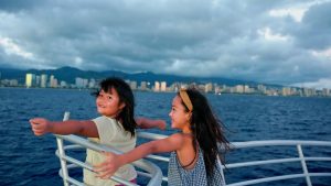 Two girls enjoying a cruise: one of the best things to do in Oahu with kids.