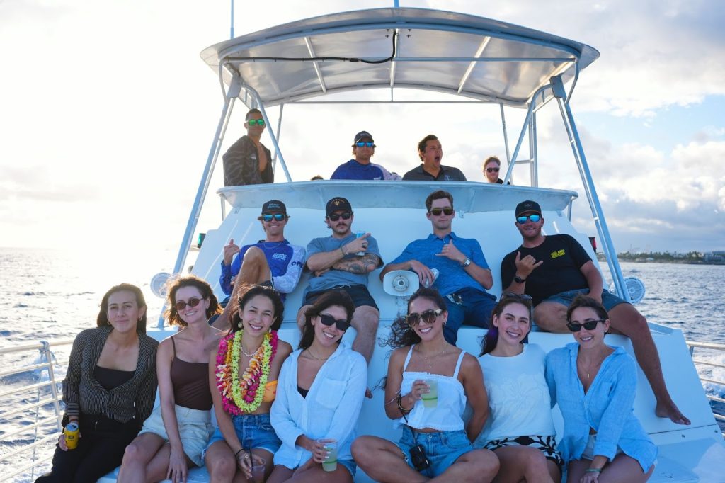 Group posing on a sunset boat in Hawaii. 