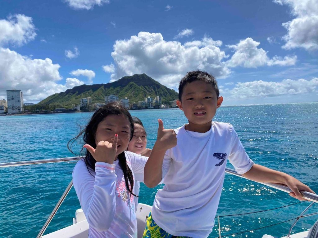 Kids enjoying a boat ride in Hawaii. 