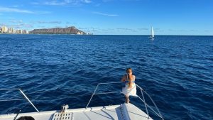 Girl enjoying ocean views in Hawaii from a boat.