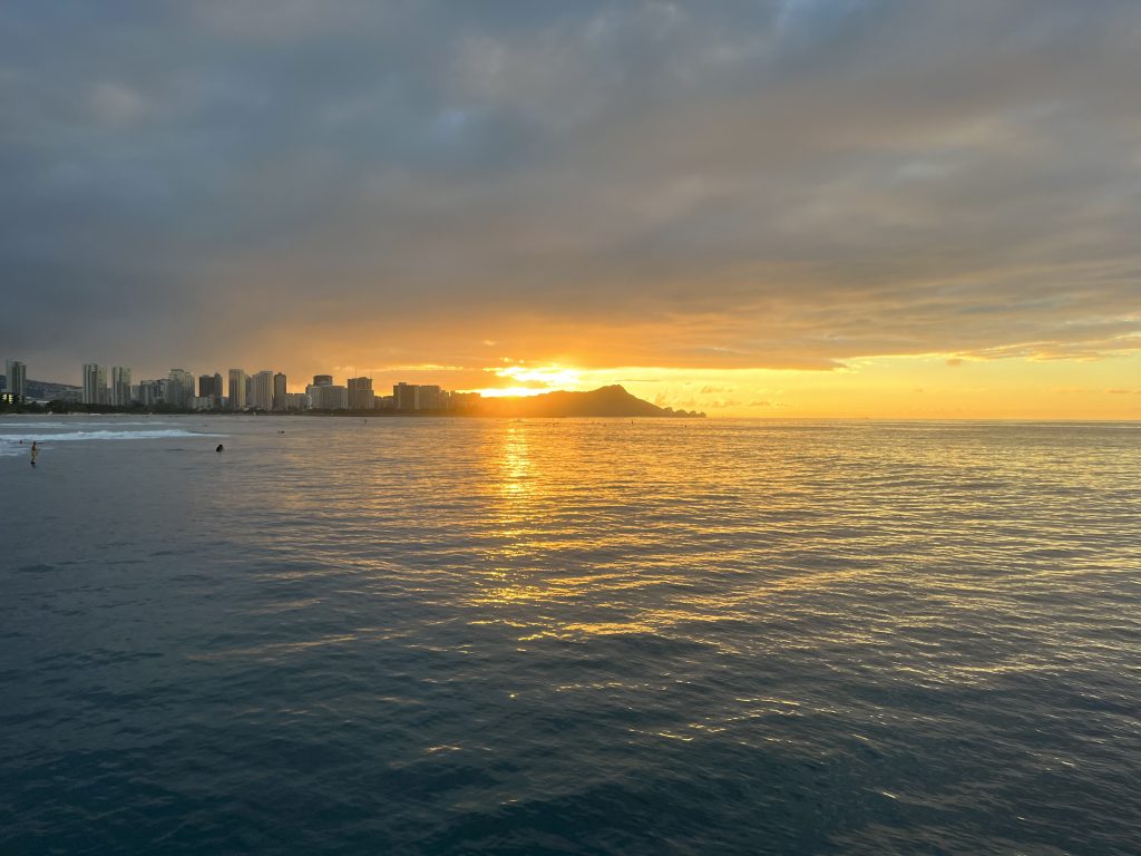 A beautiful sunrise reflecting in Waikiki waters.