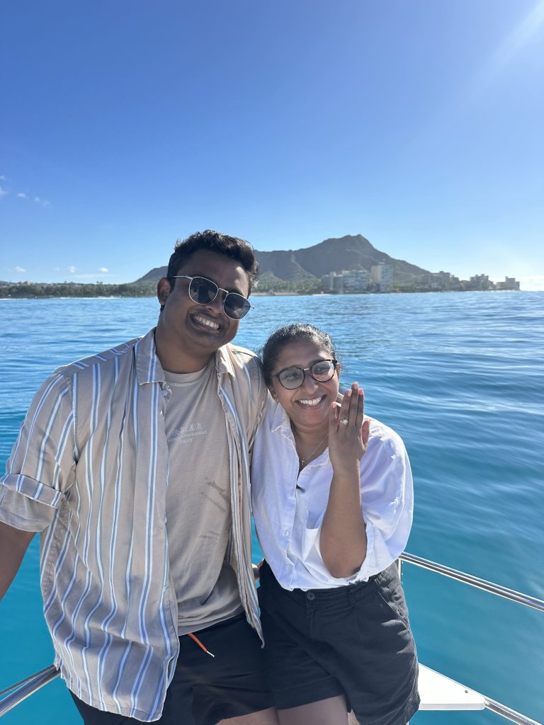 Couple enjoying a romantic private boat cruise in Honolulu while planning a memorable Hawaii proposal experience.