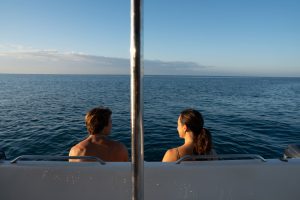 Couple enjoying ocean views in Hawaii during a boat ride.