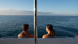 Couple enjoying ocean views in Hawaii during a boat ride.