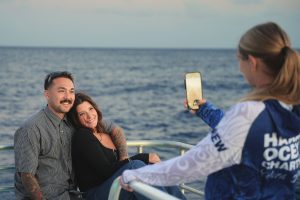 Couple posing for a photo during a Hawaii ocean charter.