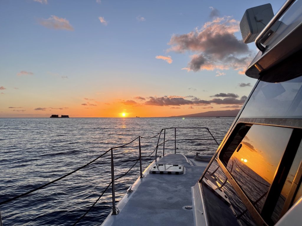 Oahu sunset cruise experience with ocean views and evening sky.