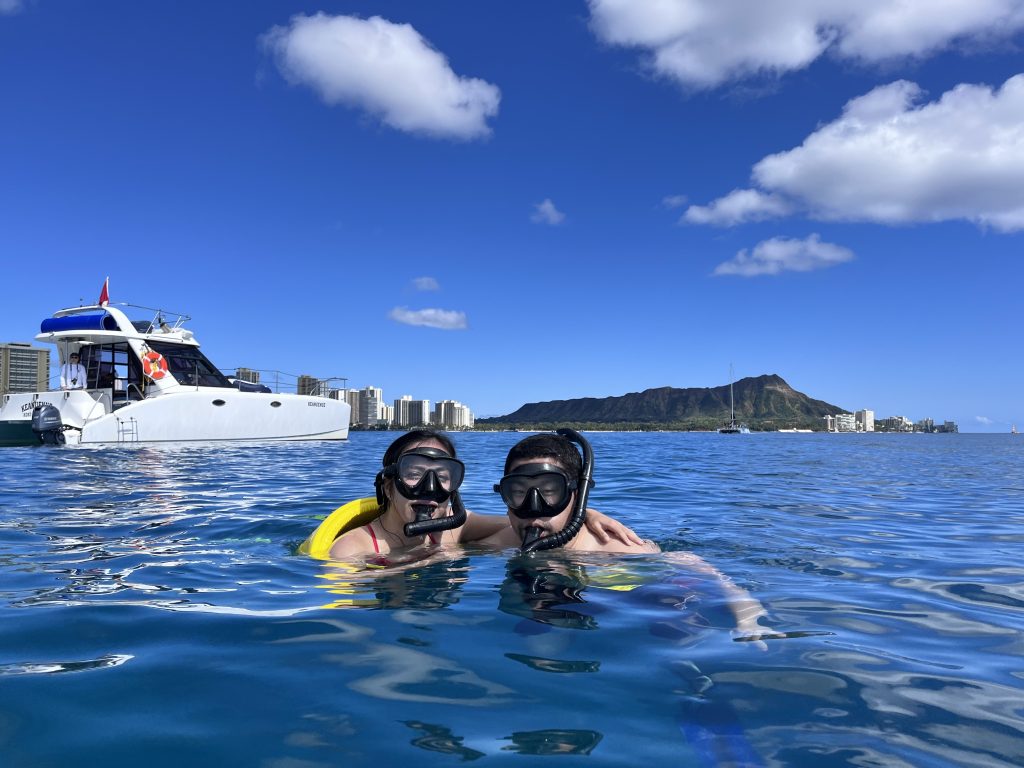 Snorkelers near Waikiki with Diamond Head backdrop