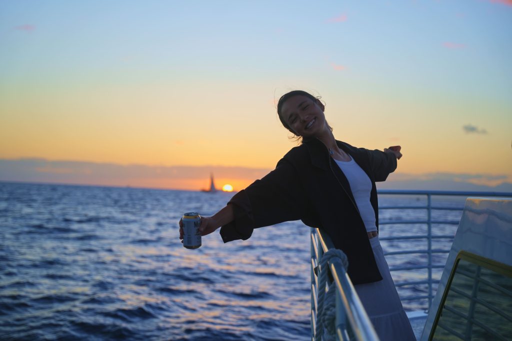 Woman enjoying a sunset boat ride in Hawaii. (1)