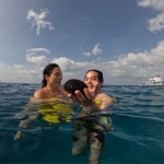 Couple in the ocean holding a sea urchin