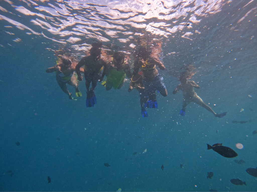Group of snorkelers swimming together underwater