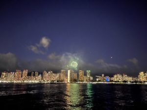 Fireworks display over Waikiki skyline from water