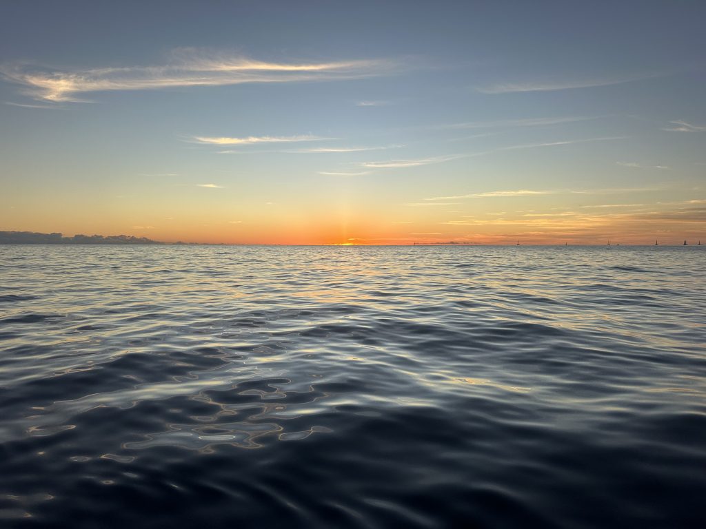 Golden sunset above peaceful ocean horizon