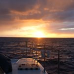Golden sunset sky viewed from sailboat deck