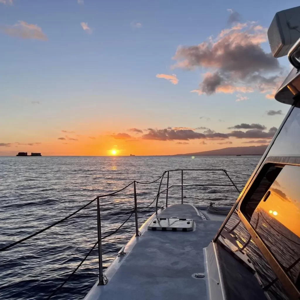 Beautiful sunset over the ocean during a private Waikiki boat cruise in Oahu, Hawaii.