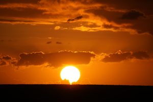 Bright orange sunset with sun on horizon