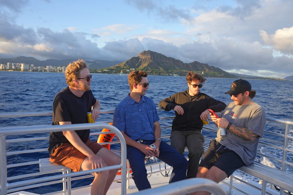Four friends chatting on boat near Diamond Head