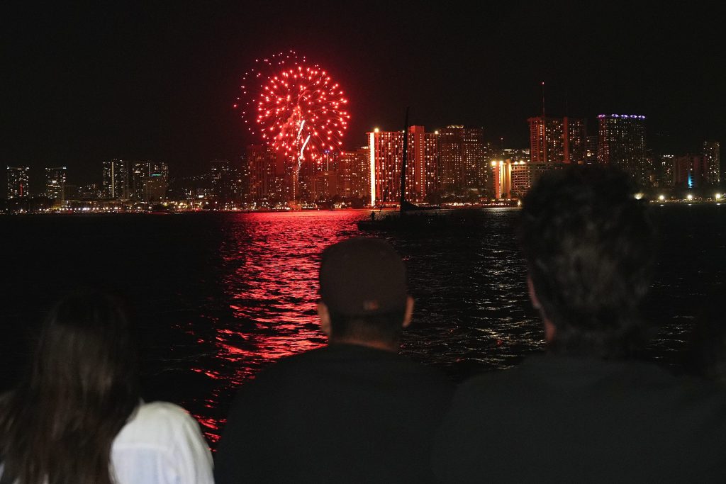 Friday night fireworks lighting up the Waikiki coastline during an evening boat cruise in Oahu.