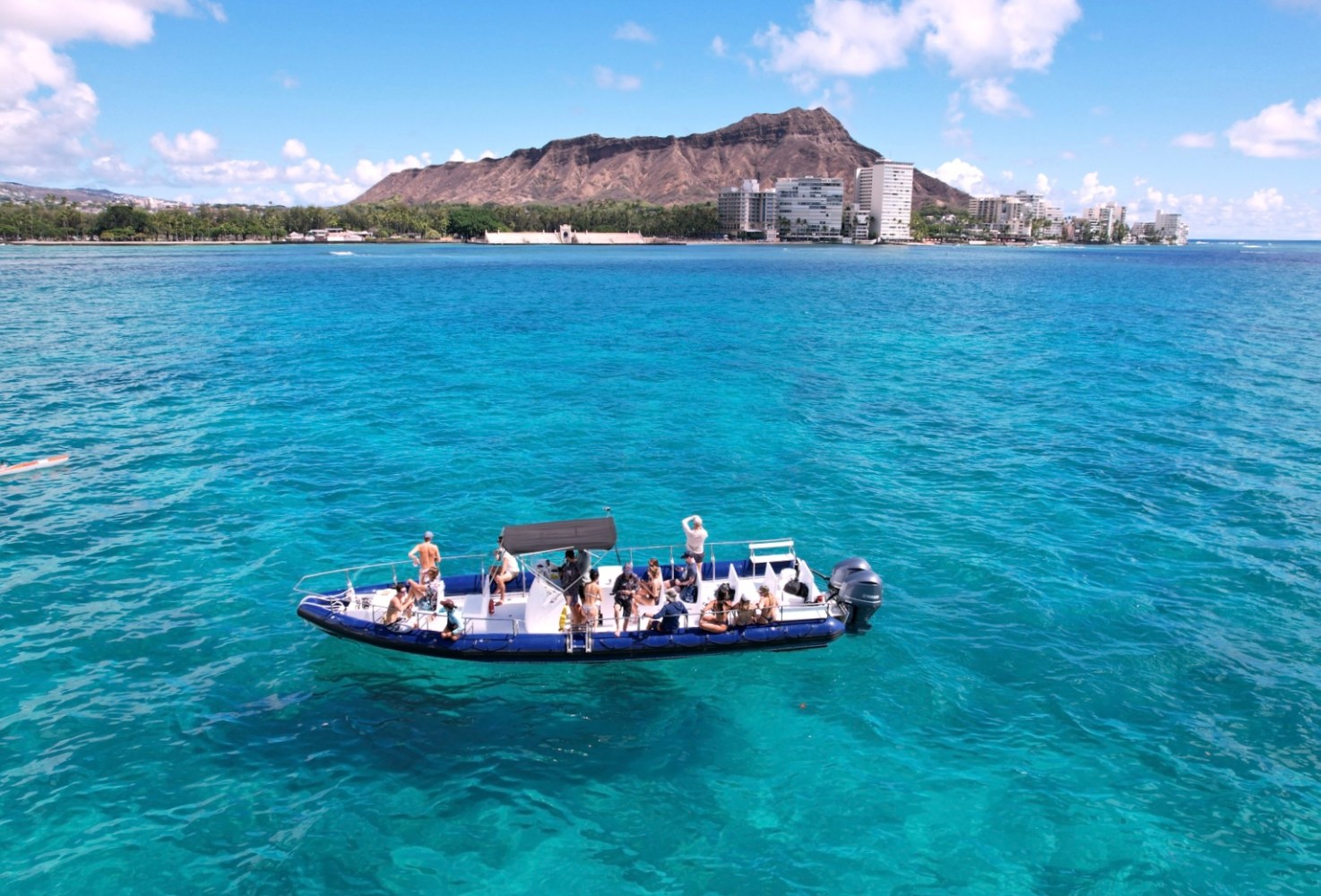 a blue and white boat sitting in the ocean